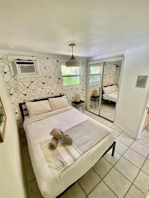 1310 Northeast 30th Street, Unit 4 Fort Lauderdale, FL 33334 - Photo 9 of 24 a bedroom with a bed and window