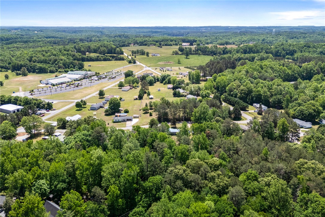 209 Short Cut Road Westminster, SC 29693 - Photo 12 of 27 Vast green landscapes surround scattered residences and commercial structures, creating a harmonious blend.