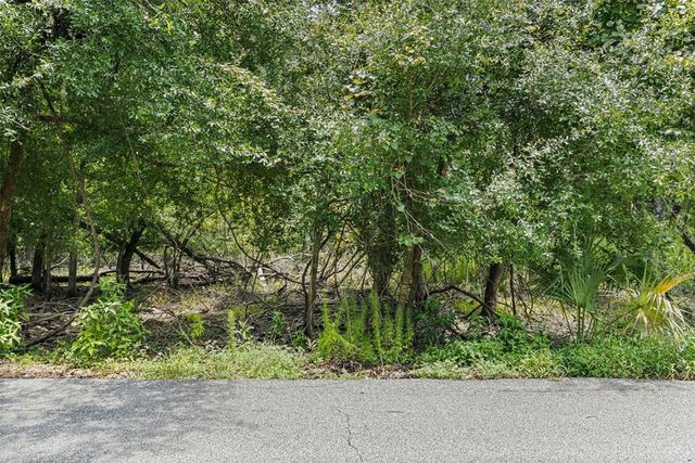 a backyard of a house with a garden and deck