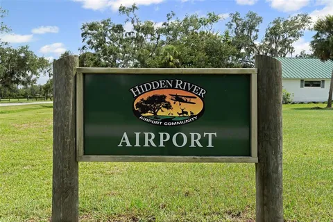 a sign that is sitting on a brick wall next to a road