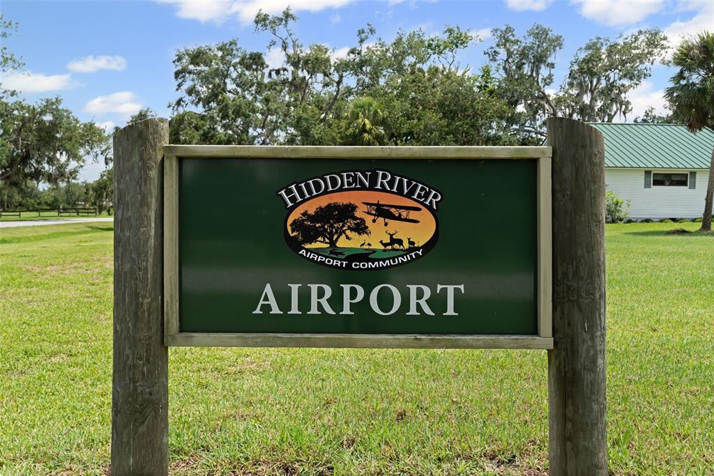 0 Hidden River Road Sarasota, FL 34240 - Photo 2 of 18 a sign that is sitting on a brick wall next to a road