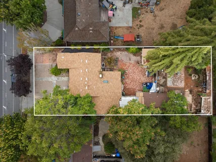 an aerial view of a house with a yard