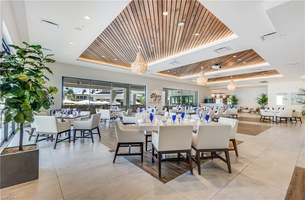 275 Indies Way, Unit 1002 Naples, FL 34110 - Photo 36 of 48 Dining area with wood ceiling, a raised ceiling, visible vents, and light tile patterned flooring