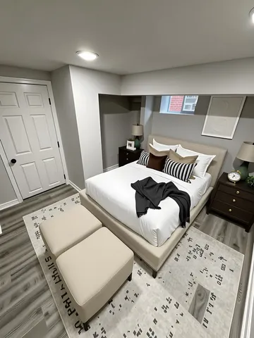 a bedroom with a bed and a night stand