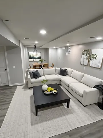 a living room with furniture couches and kitchen view