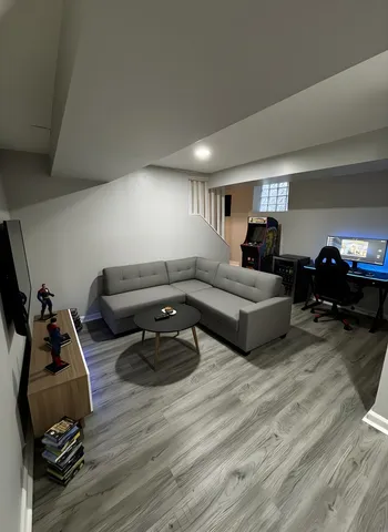 a living room with furniture and a wooden floor