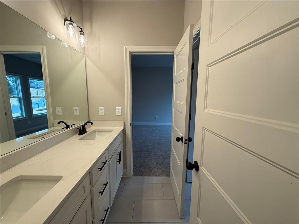 3838 Cheyenne Lane Jefferson, GA 30549 - Photo 26 of 29 a bathroom with a double vanity sink and a mirror