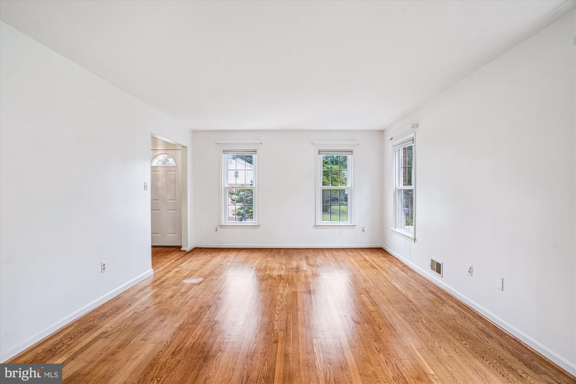 1913 Hopefield Road Silver Spring, MD 20905 - Photo 12 of 67 an empty room with wooden floor and windows