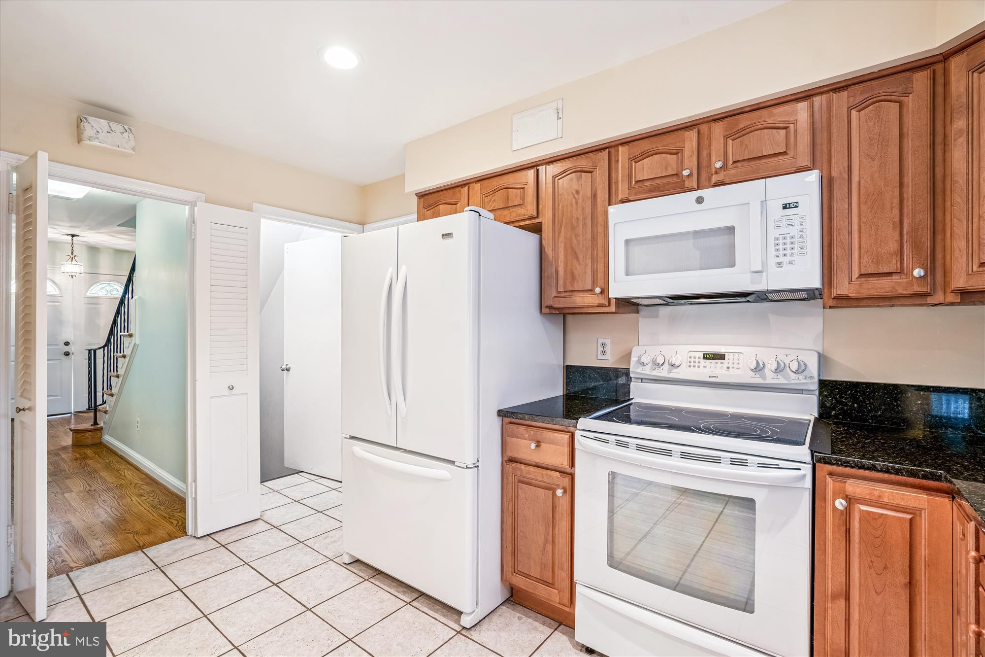 1913 Hopefield Road Silver Spring, MD 20905 - Photo 21 of 67 a kitchen with white cabinets and white appliances