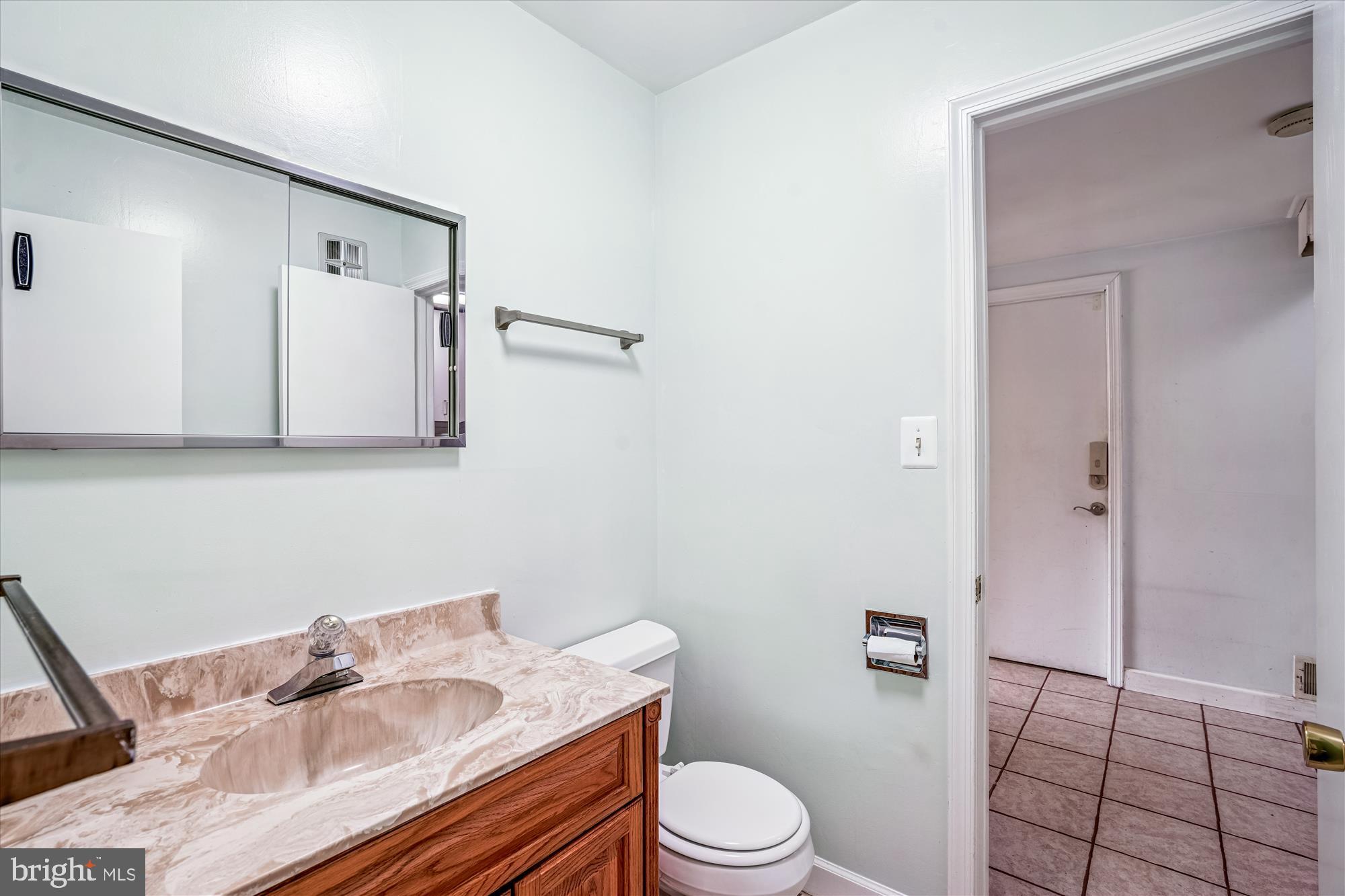 1913 Hopefield Road Silver Spring, MD 20905 - Photo 33 of 67 a white toilet sitting next to a bathroom sink