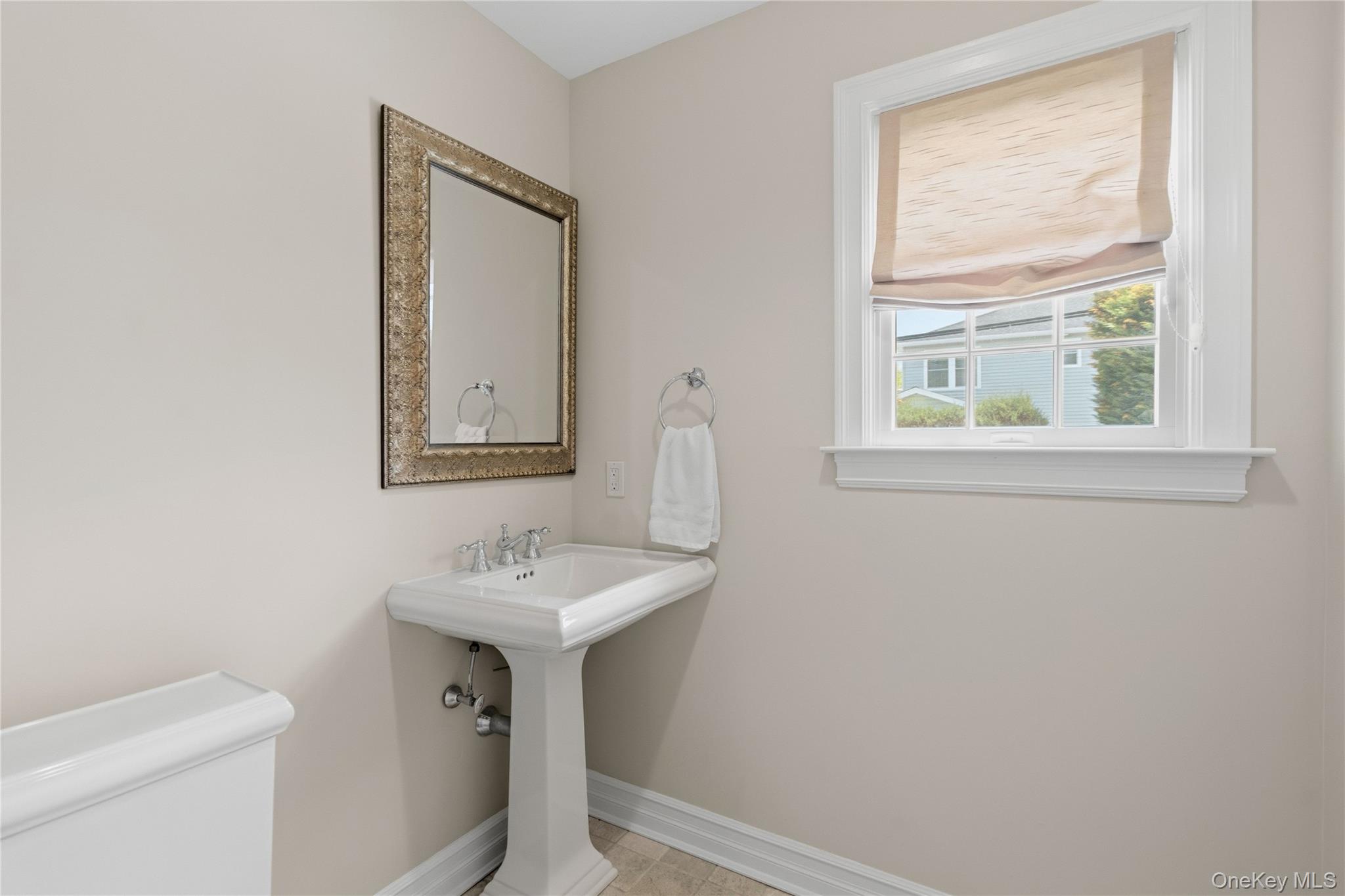 47 Syosset Circle Syosset, NY 11791 - Photo 18 of 30 a bathroom with a sink a toilet and a mirror
