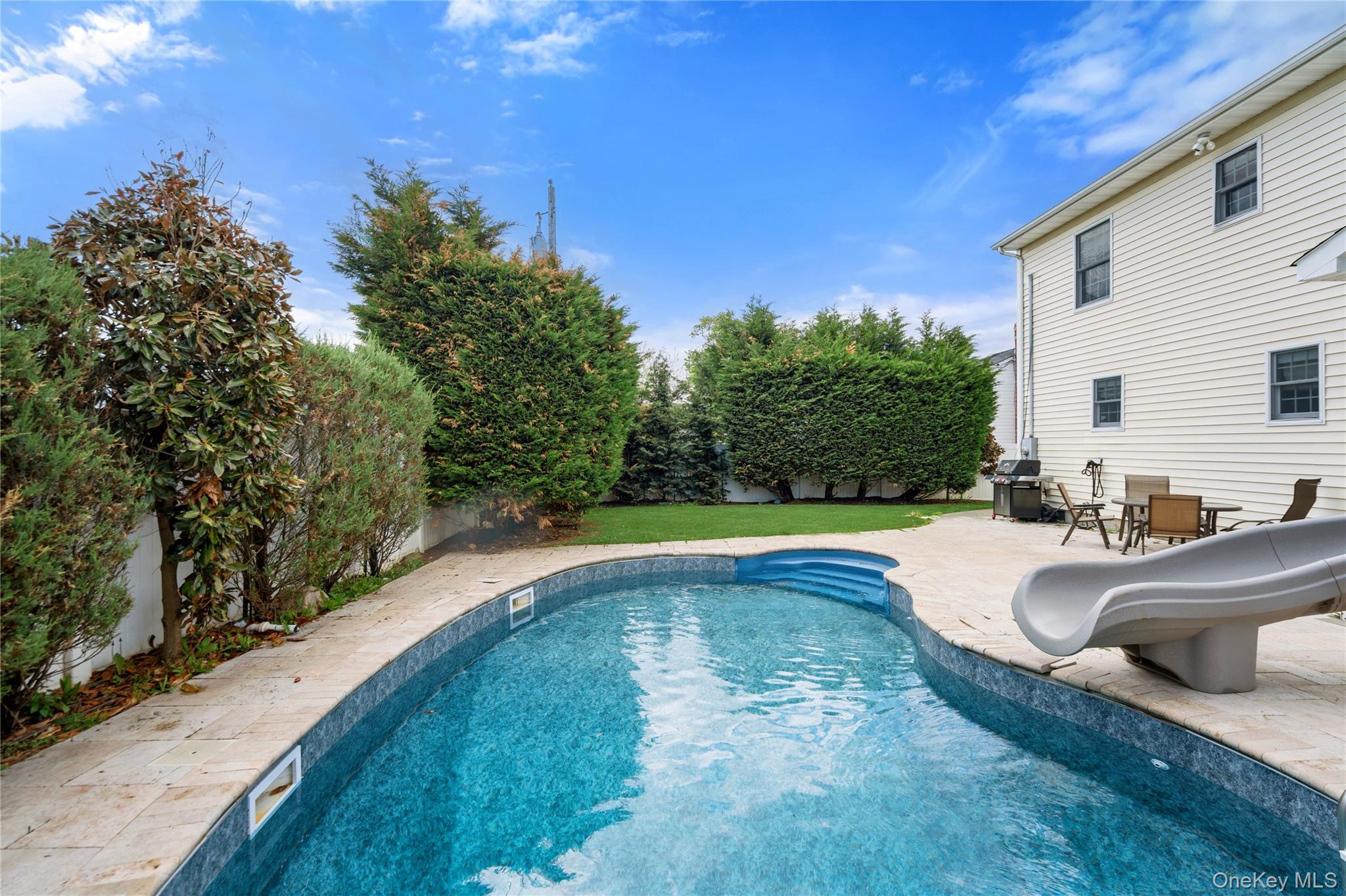 47 Syosset Circle Syosset, NY 11791 - Photo 28 of 30 a swimming pool with outdoor seating and yard