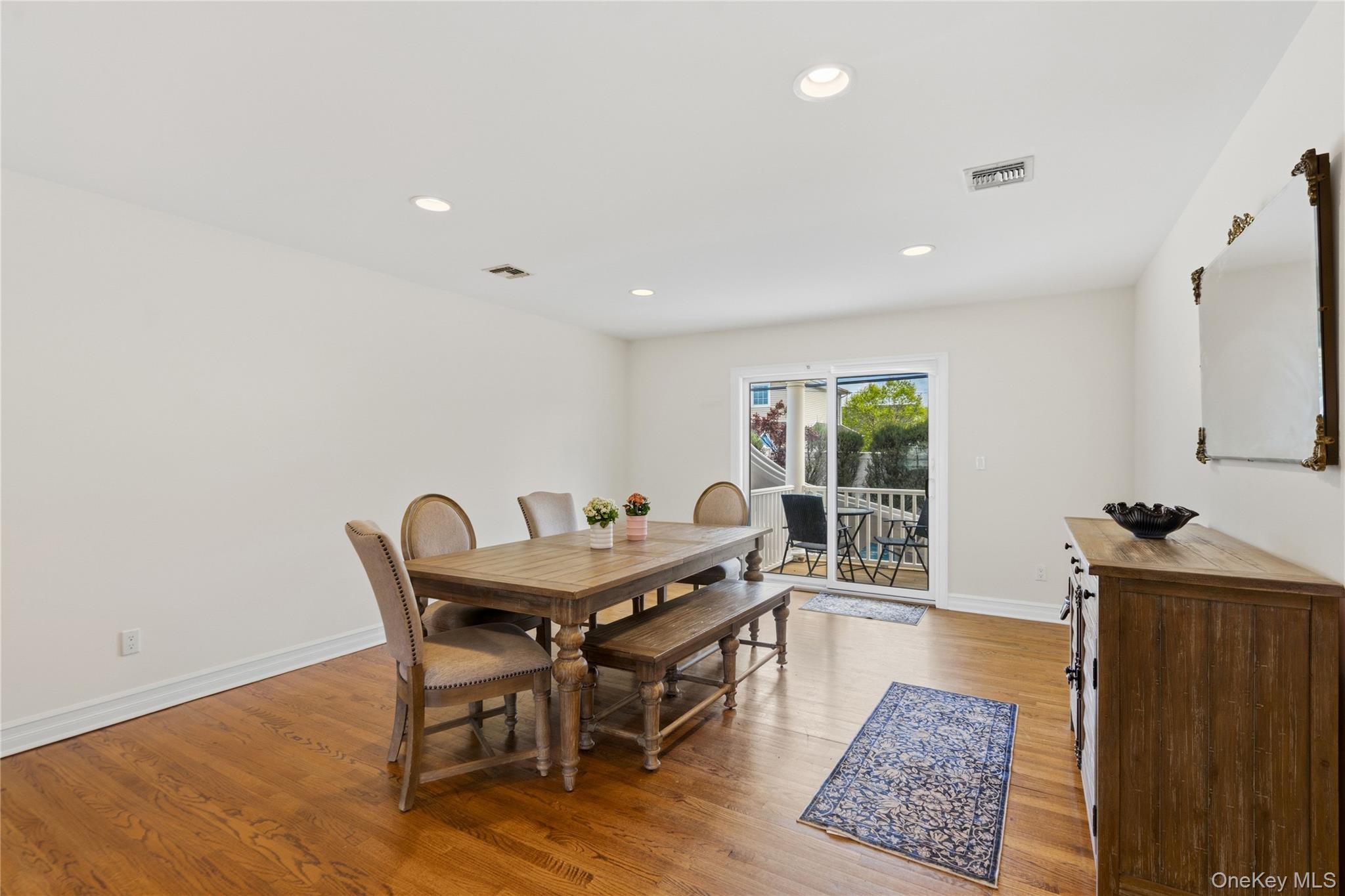 47 Syosset Circle Syosset, NY 11791 - Photo 9 of 30 a view of a dining room with furniture and wooden floor