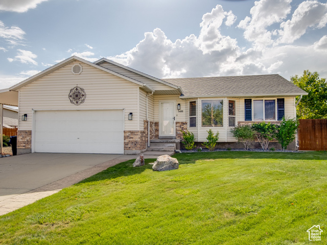 5480 Sun Ridge Court Kearns, UT 84118 - Photo 1 of 1 Ranch-style house featuring a garage, brick siding, driveway, and a shingled roof