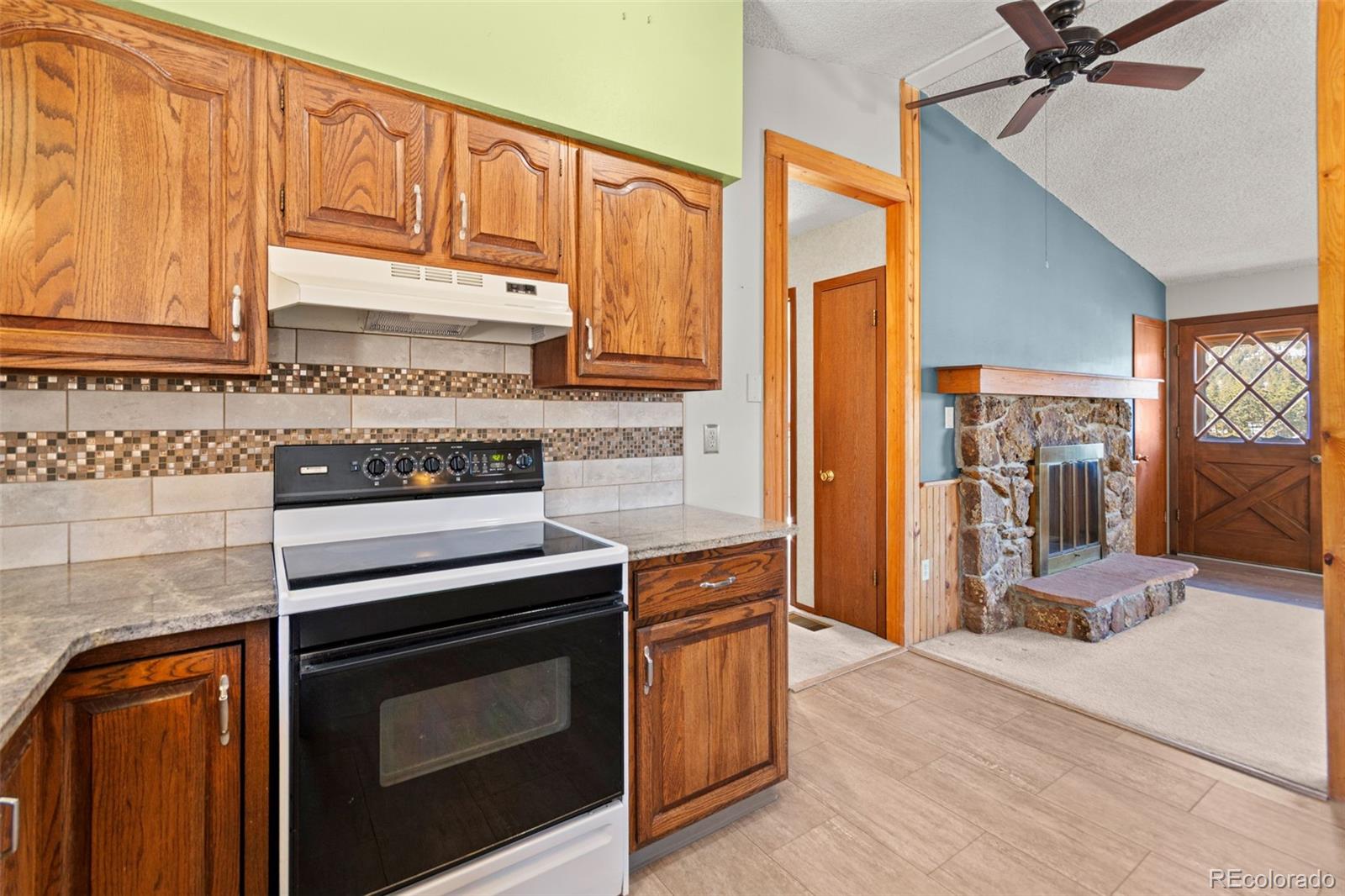 237 Homestead Road Bailey, CO 80421 - Photo 14 of 43 a kitchen with stainless steel appliances granite countertop a stove a sink and a refrigerator