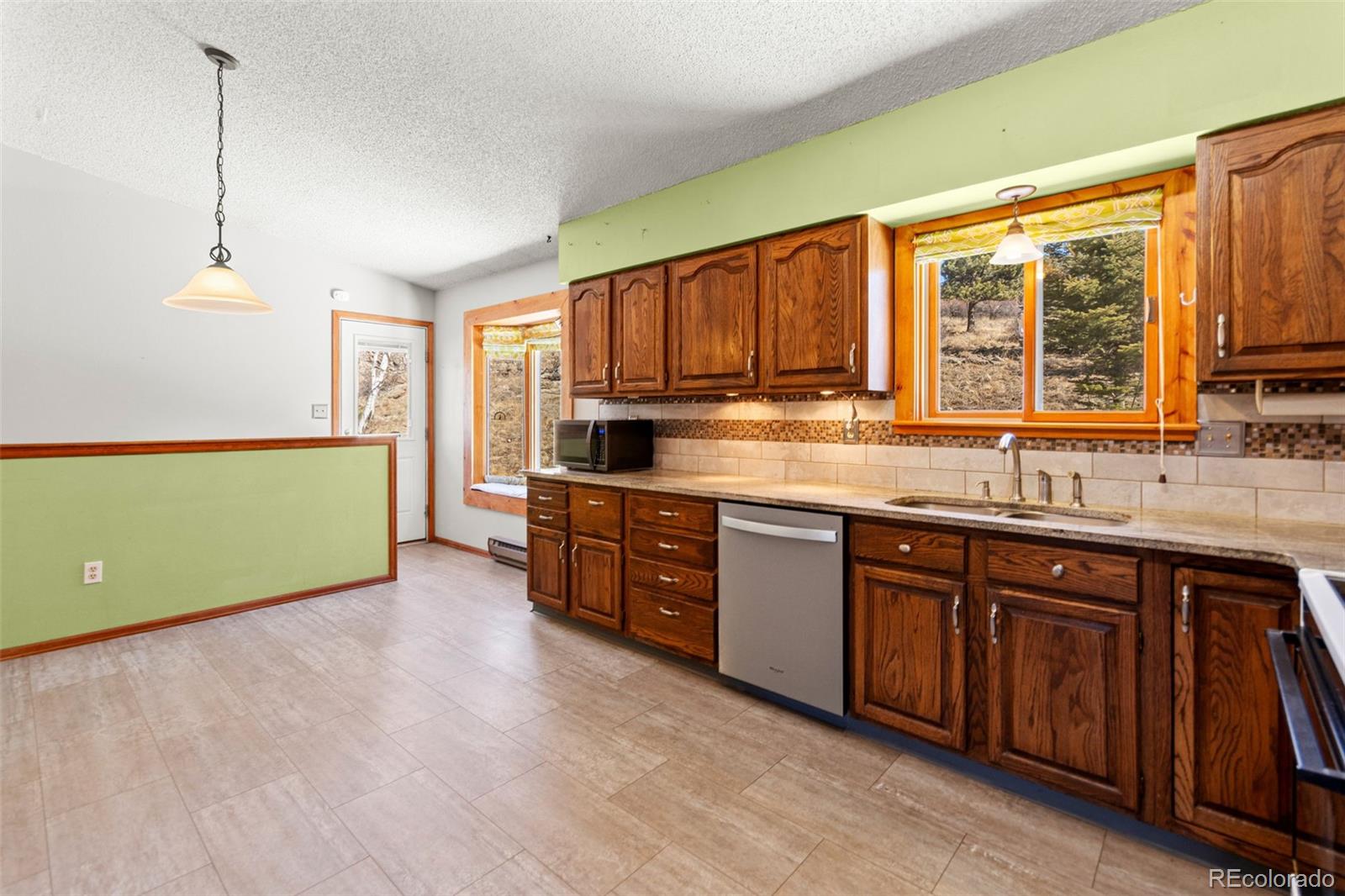 237 Homestead Road Bailey, CO 80421 - Photo 16 of 43 a kitchen with a sink and a large window