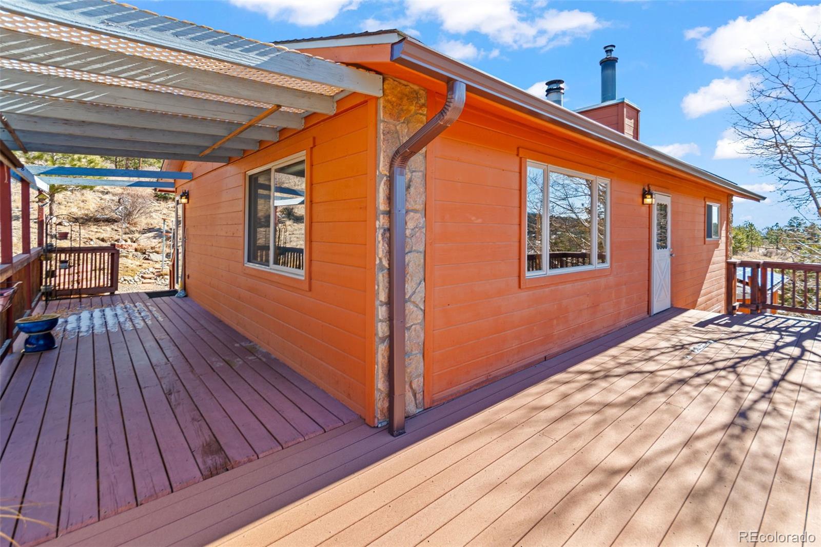 237 Homestead Road Bailey, CO 80421 - Photo 7 of 43 a backyard of a house with wooden floor