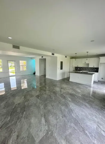 a view of a kitchen with a sink and a stove top oven