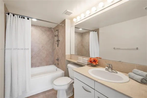 a bathroom with a sink toilet tub and shower