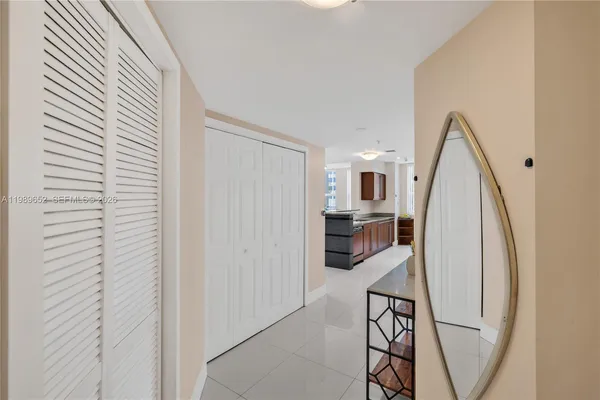 a view of a living room with furniture and entryway