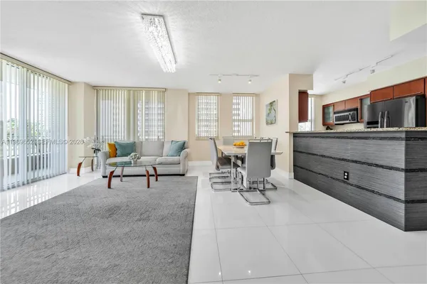 a living room with furniture and large windows