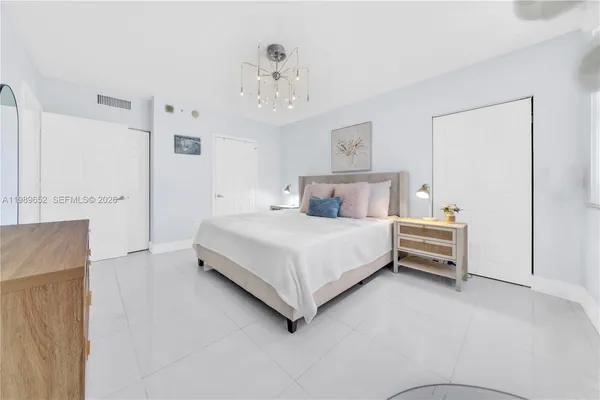 a bed room with a bed and a chandelier