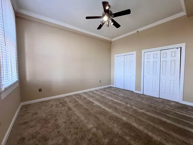 a view of a livingroom with a ceiling fan and window