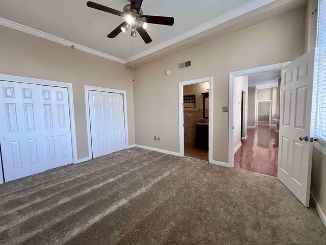 a view of a room with a ceiling fan