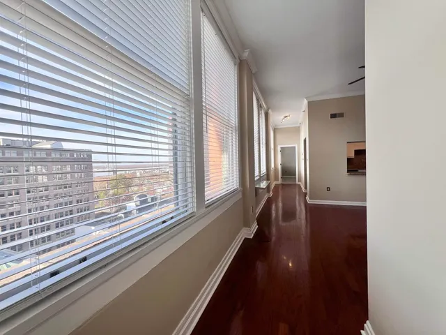 a view of a room with wooden floor and a window