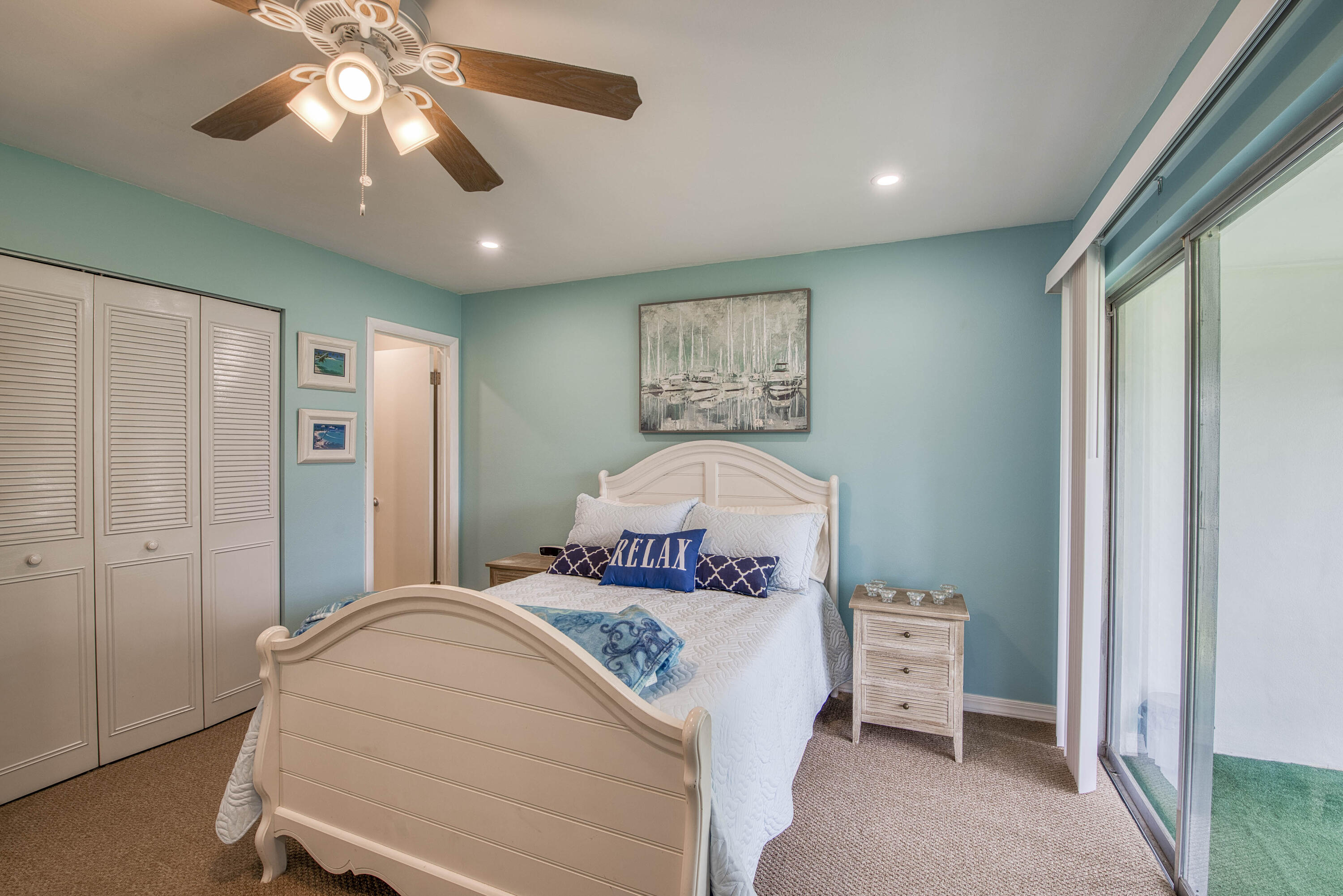 2929 Southeast Ocean Boulevard, Unit 1146 Stuart, FL 34996 - Photo 11 of 19 a bedroom with a bed and a chandelier