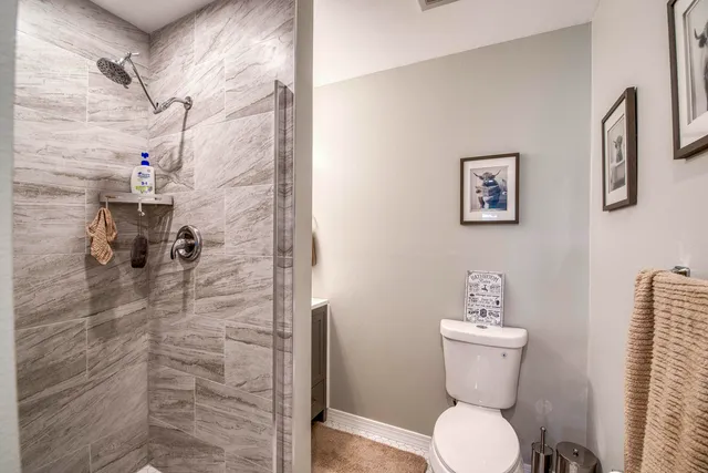 a bathroom with a toilet and a shower