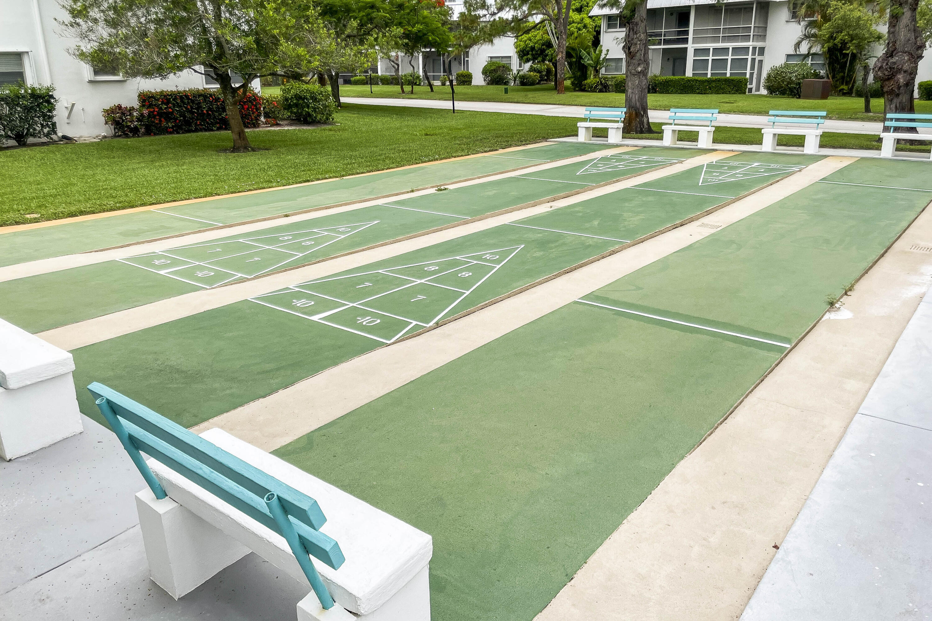 2929 Southeast Ocean Boulevard, Unit 1146 Stuart, FL 34996 - Photo 18 of 19 a view of a tennis ground with large trees
