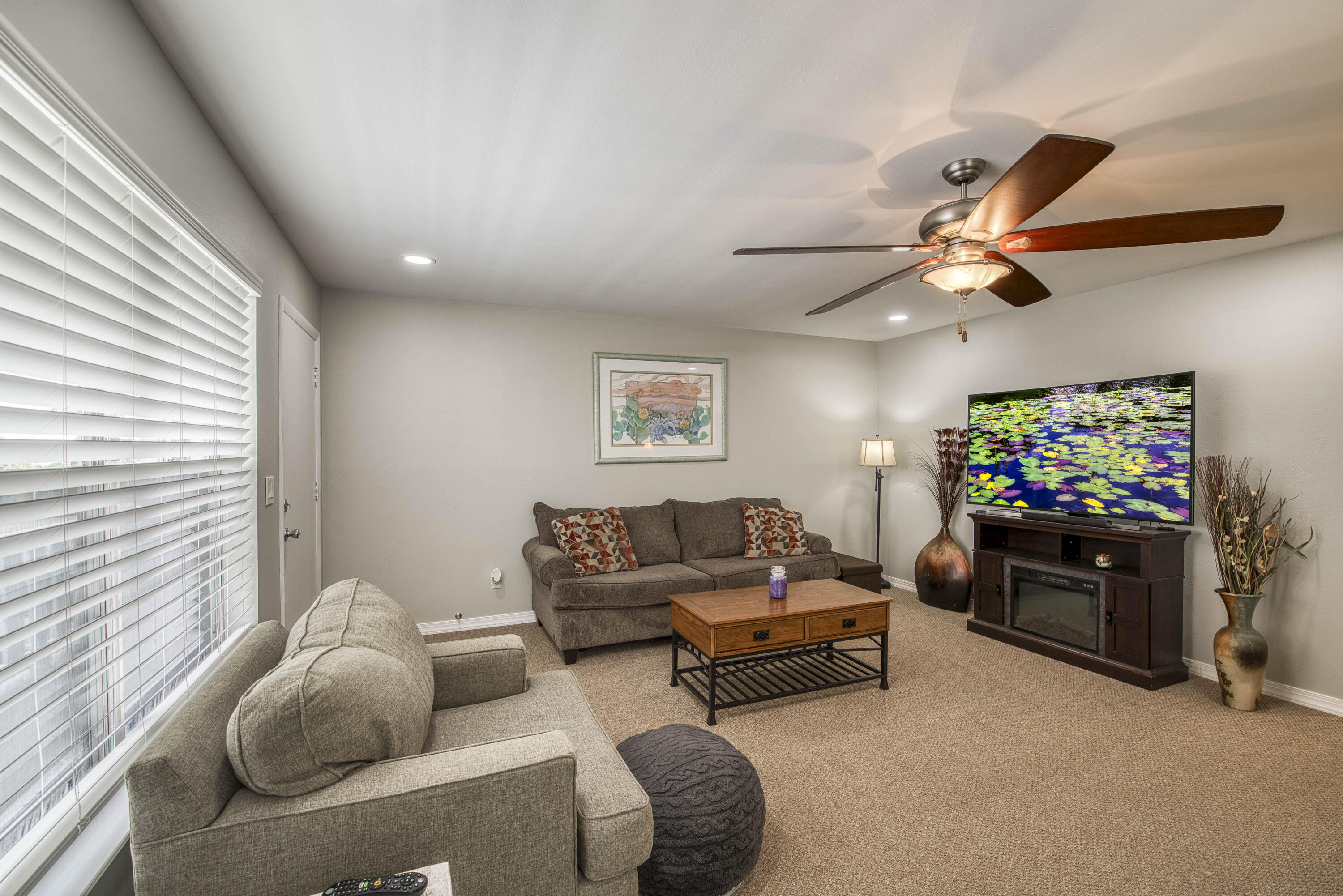 2929 Southeast Ocean Boulevard, Unit 1146 Stuart, FL 34996 - Photo 2 of 19 a living room with furniture and a flat screen tv