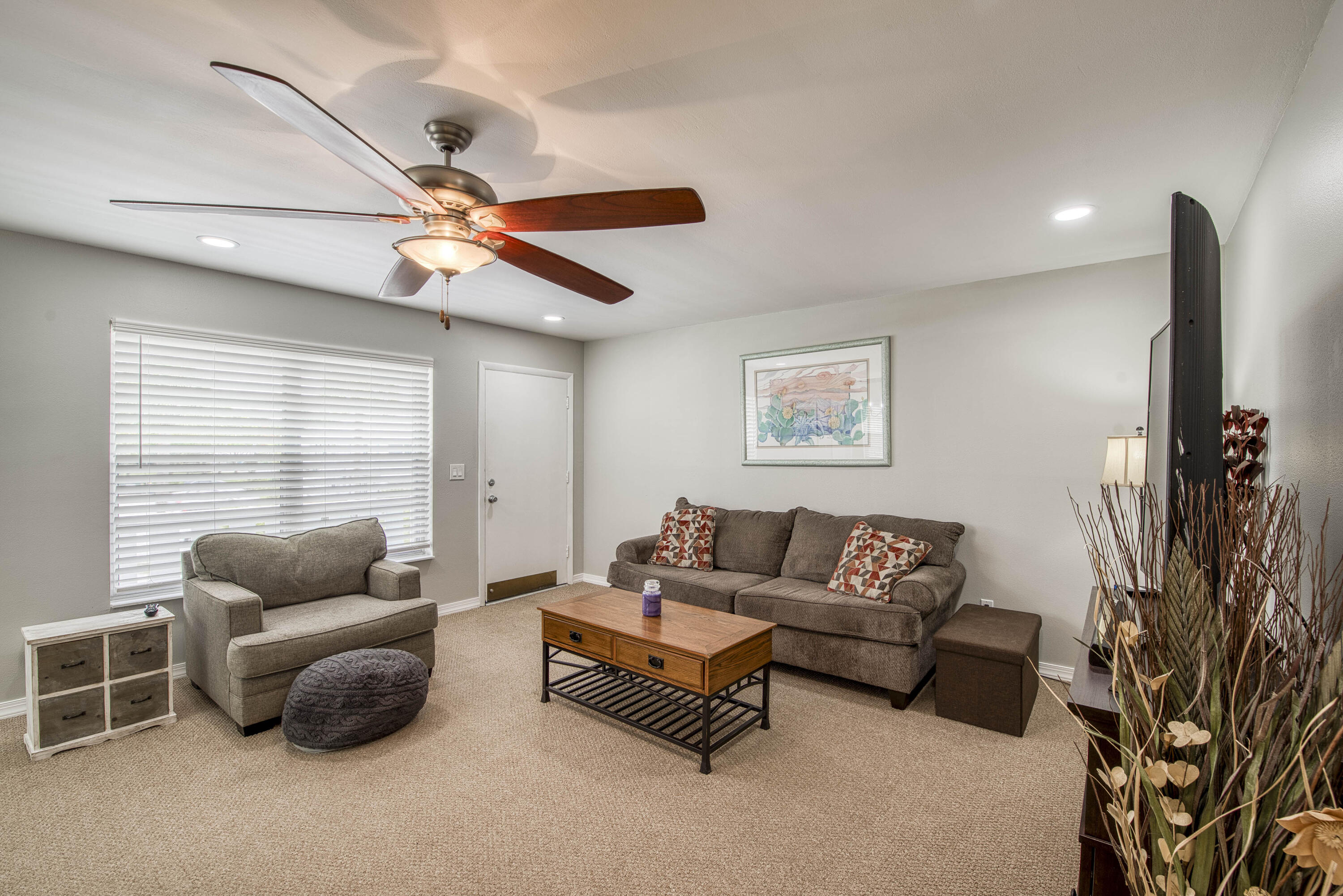 2929 Southeast Ocean Boulevard, Unit 1146 Stuart, FL 34996 - Photo 3 of 19 a living room with furniture and a flat screen tv