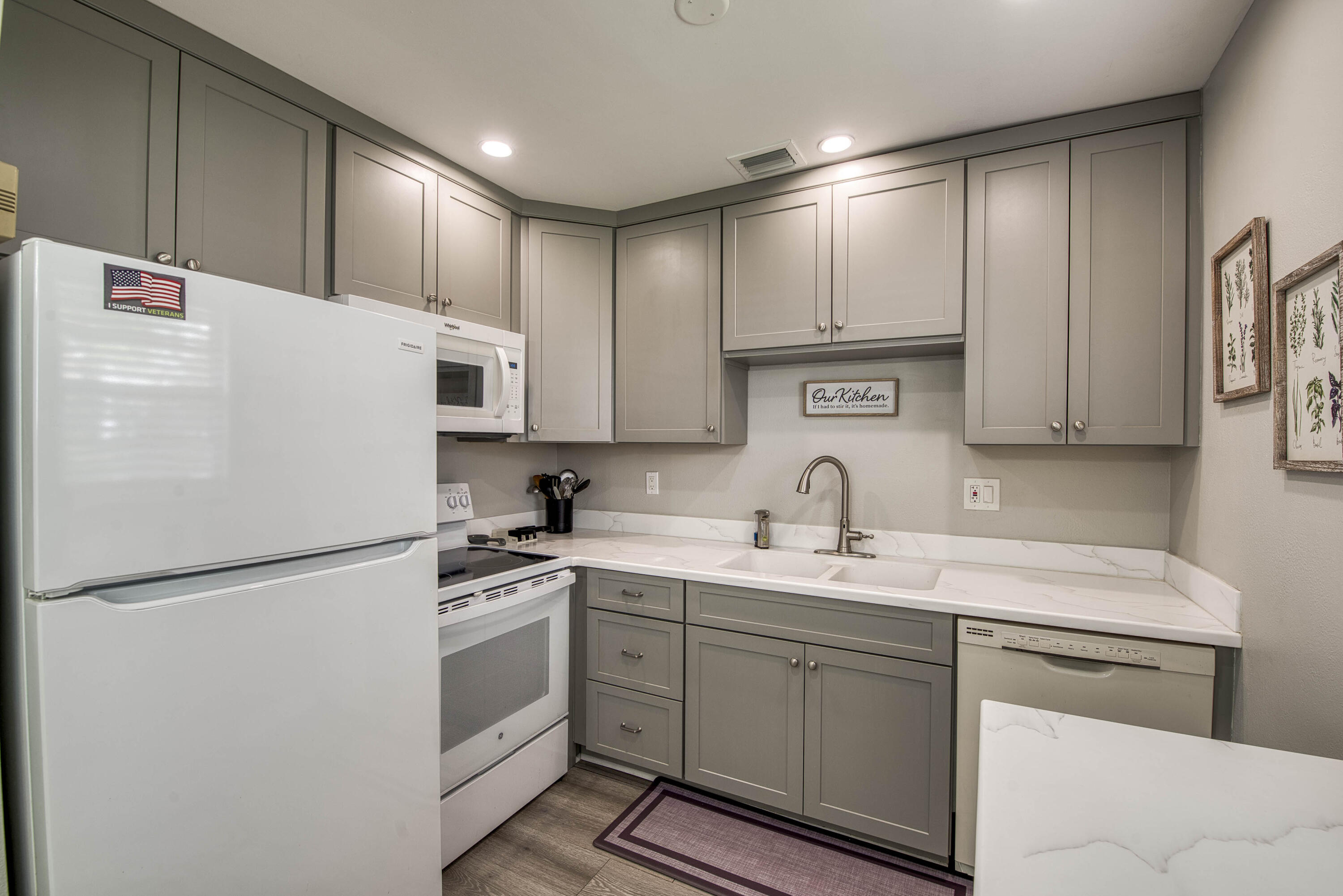 2929 Southeast Ocean Boulevard, Unit 1146 Stuart, FL 34996 - Photo 8 of 19 a kitchen with appliances cabinets and a sink