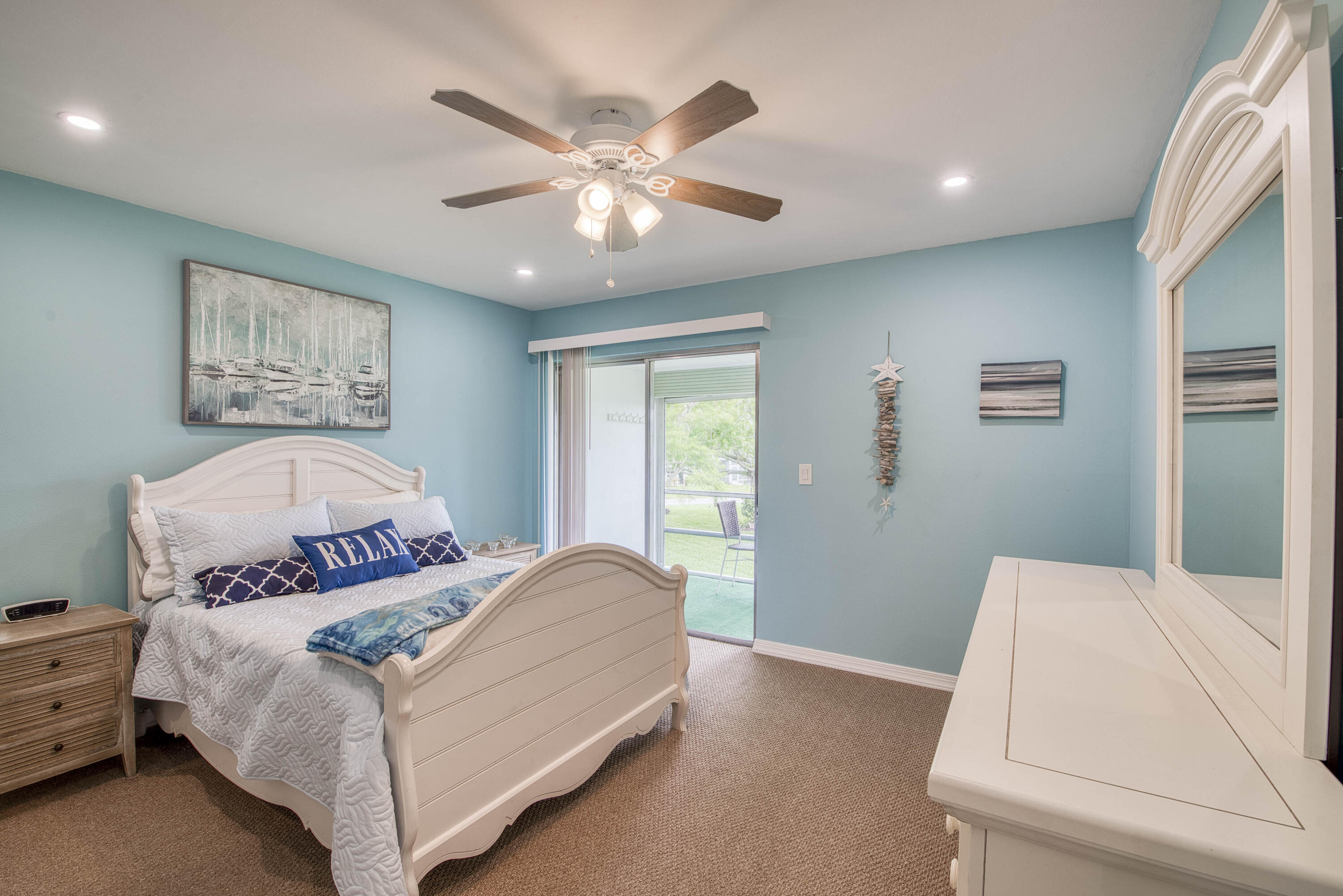 2929 Southeast Ocean Boulevard, Unit 1146 Stuart, FL 34996 - Photo 10 of 19 a bedroom with a large bed and a chandelier