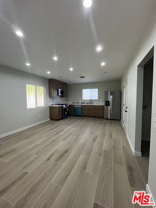 1842 Deodora Street Simi Valley, CA 93065 - Photo 1 of 9 a view of empty room with wooden floor and window