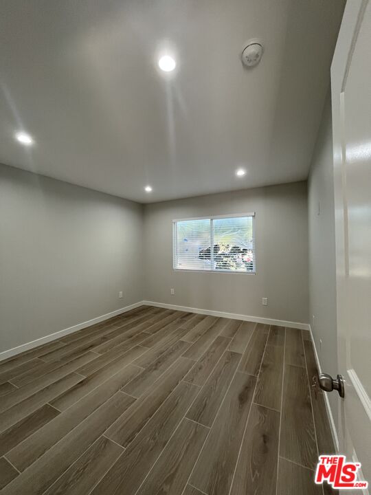 1842 Deodora Street Simi Valley, CA 93065 - Photo 3 of 9 an empty room with wooden floor and ceiling fan