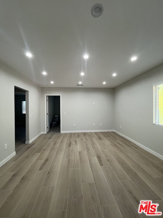 1842 Deodora Street Simi Valley, CA 93065 - Photo 4 of 9 an empty room with wooden floor and closet