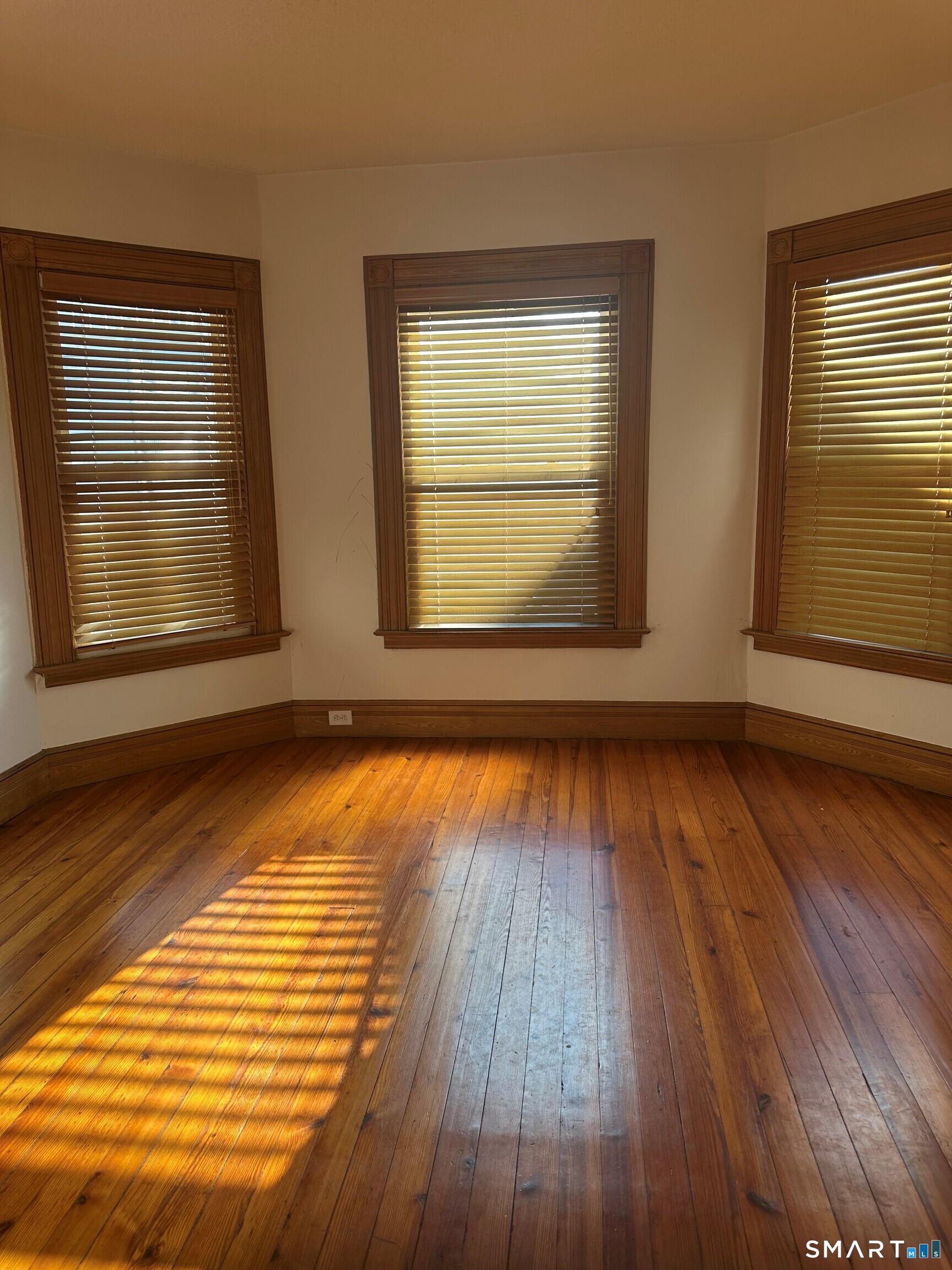 35 Tilton Street New Haven, CT 06511 - Photo 5 of 36 a view of an empty room with wooden floor and a window