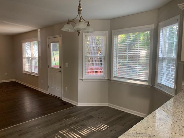 8320 Hobhouse Circle Raleigh, NC 27615 - Photo 5 of 16 a view of an empty room with wooden floor and a window