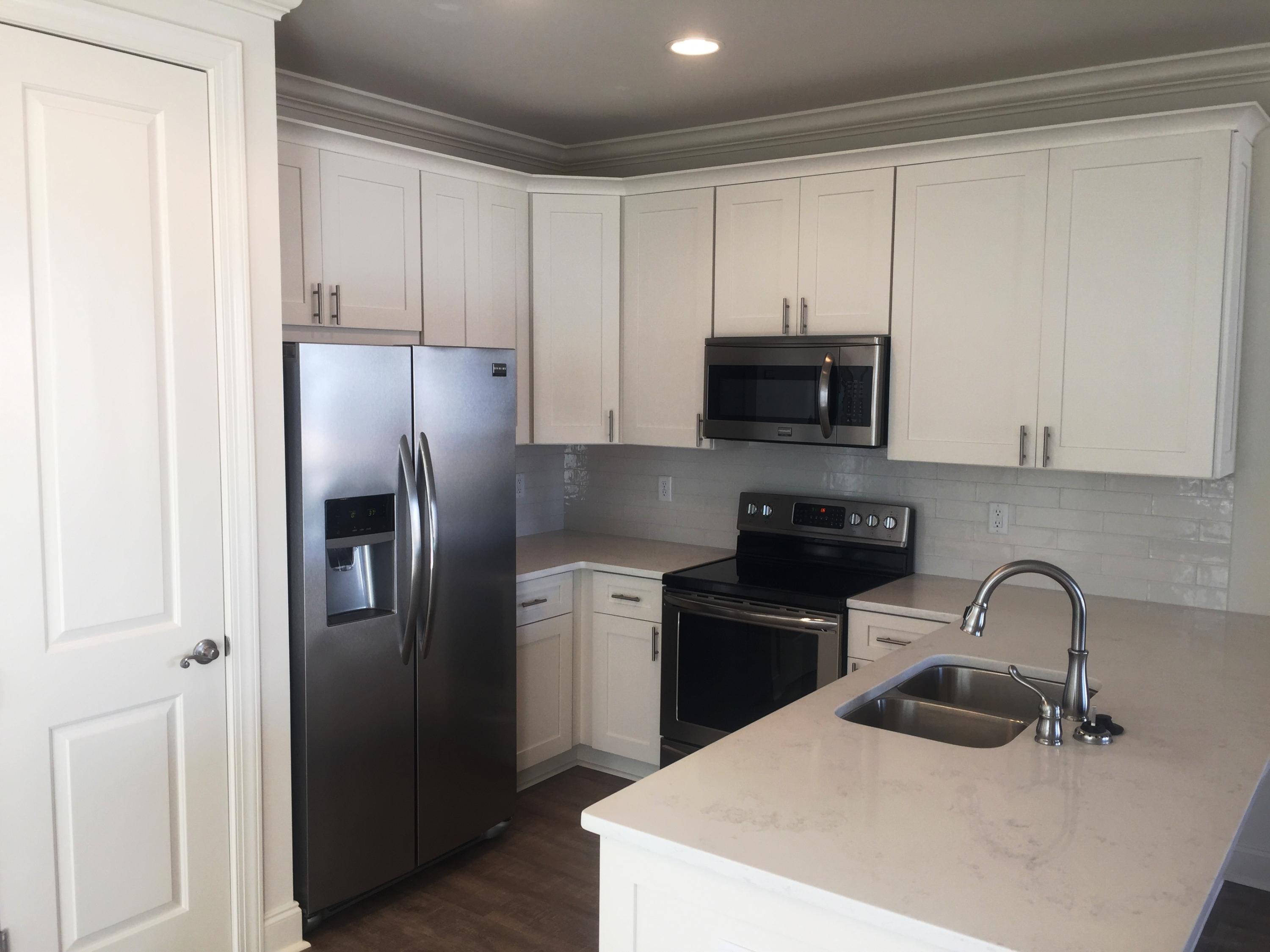 177 Chapman Street Santa Rosa Beach, FL 32459 - Photo 5 of 25 a kitchen with stainless steel appliances granite countertop a refrigerator stove top oven and sink