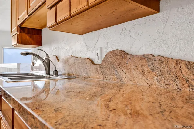 a kitchen with stainless steel appliances granite countertop a stove and a sink