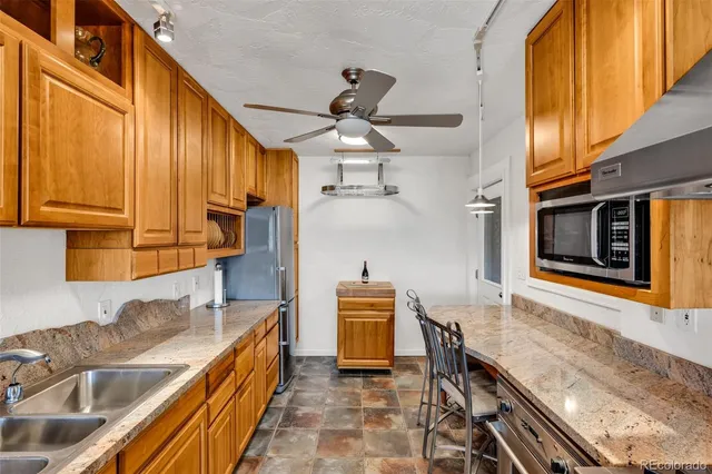 a kitchen with granite countertop a sink and cabinets