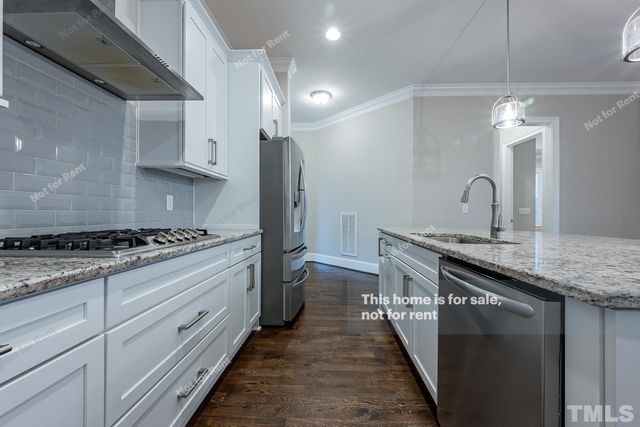 a kitchen with sink stove and cabinets
