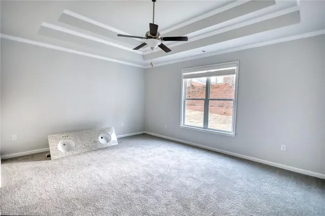 a view of a livingroom with a ceiling fan and window