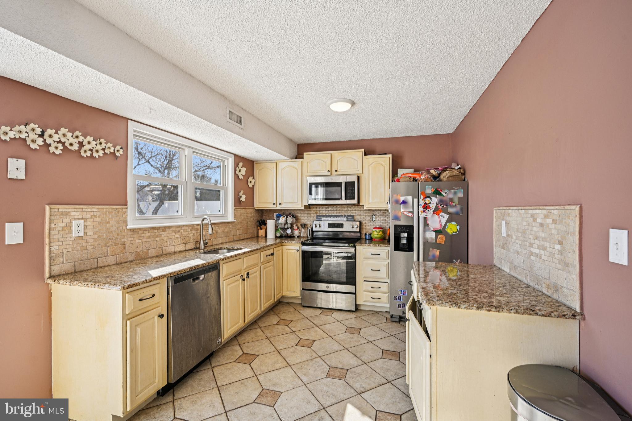 135 Windward Drive Barnegat, NJ 08005 - Photo 12 of 55 a kitchen with a sink stove and cabinets