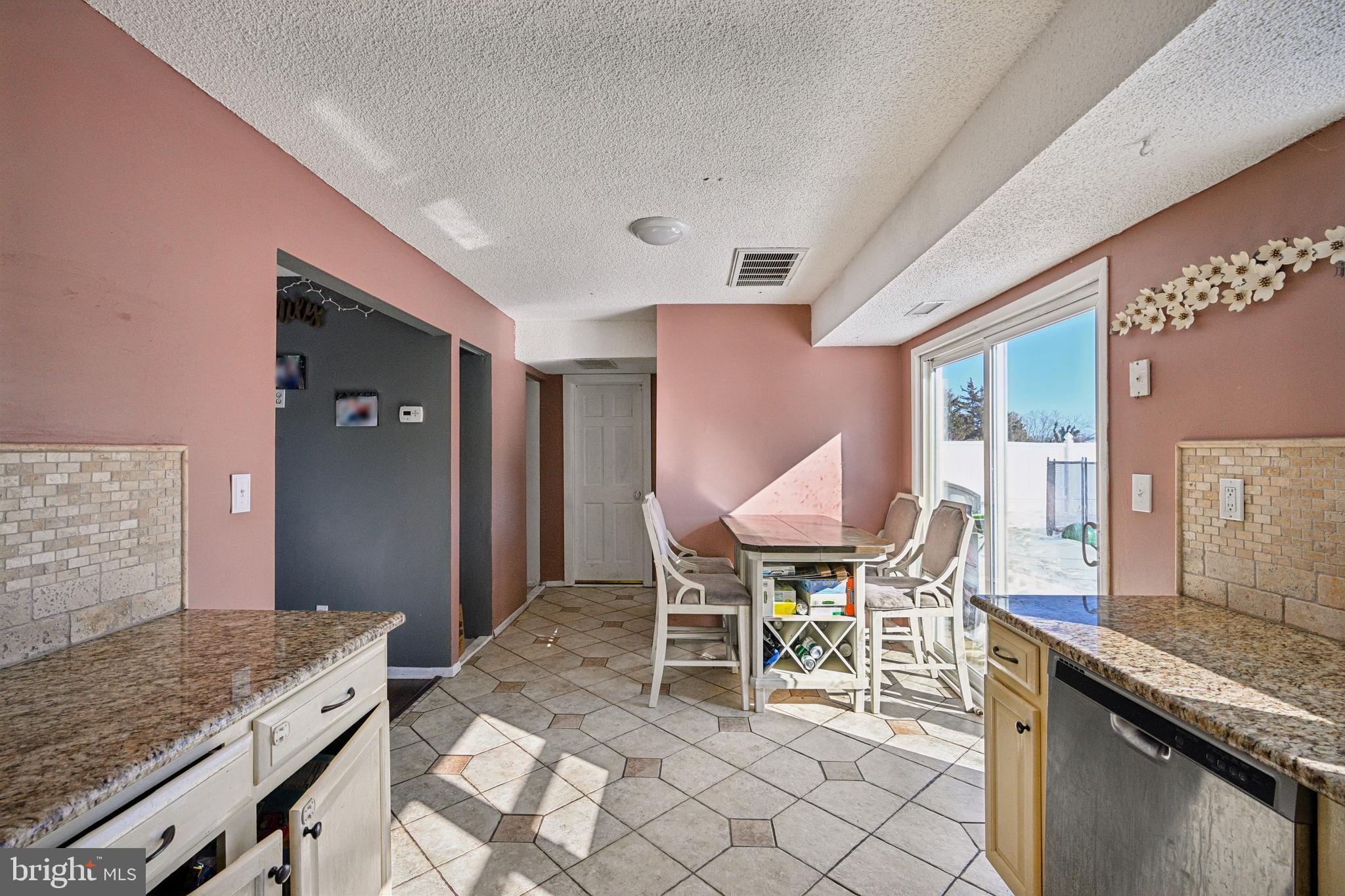 135 Windward Drive Barnegat, NJ 08005 - Photo 10 of 55 a kitchen with granite countertop a table and chairs in it