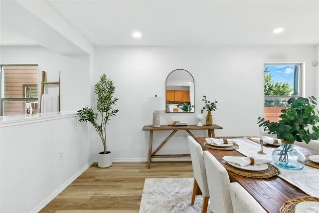 a living room with furniture a mirror and a flat screen tv