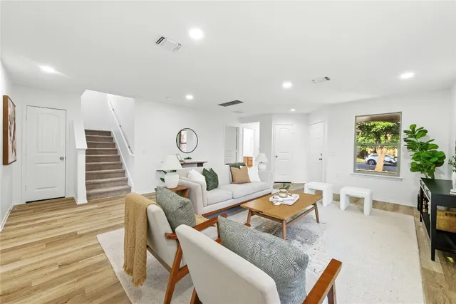 a living room with furniture and a potted plant